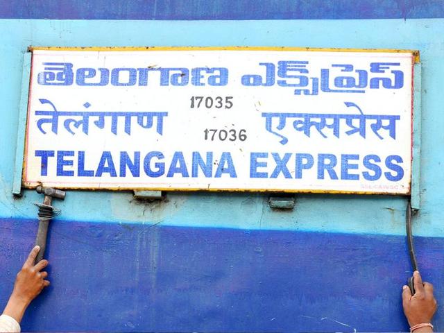 Railway technicians remove a board on an Express train coach during a 48-hour railway strike in the Telangana region in Hyderabad.