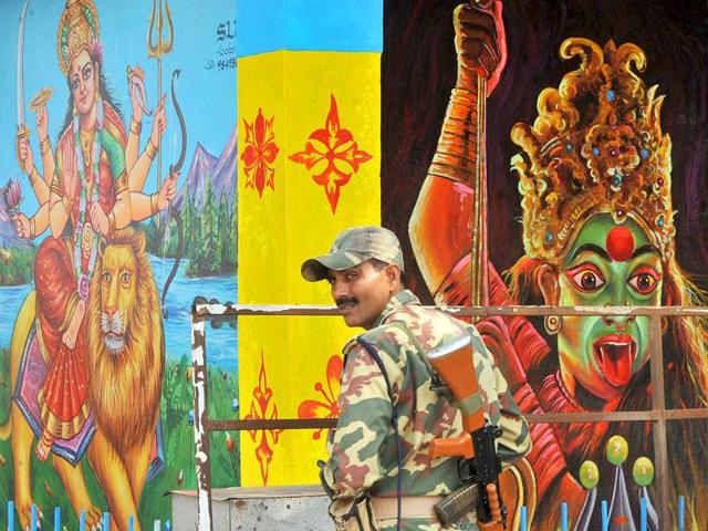A paramilitary serviceman keeps watch outside a station during a 48-hour railway strike in the Telangana region in Hyderabad.