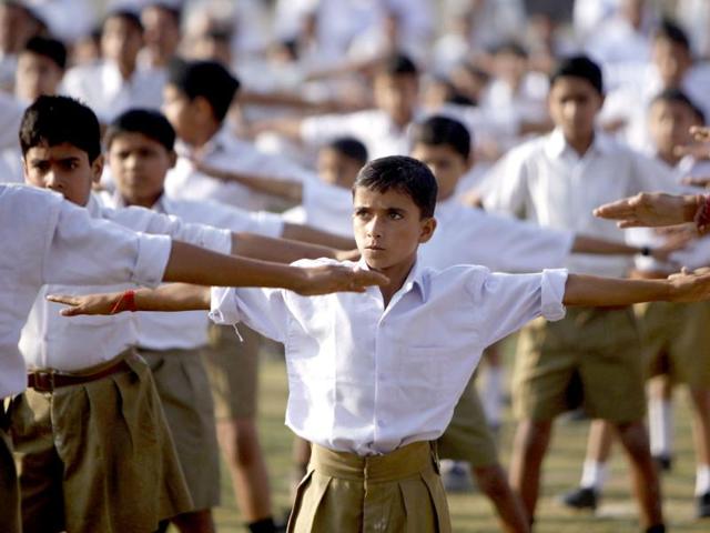 Volunteers of Rashtriya Swayamsevak Sangh (RSS) perform yoga during a public meeting in Jammu.