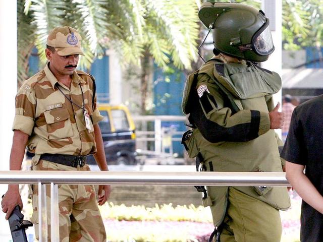 The bomb disposal squad member shows a thumb-up sign to his colleagues after checking an unattended bag hanged on a trolley at the prepaid Taxi Stand.