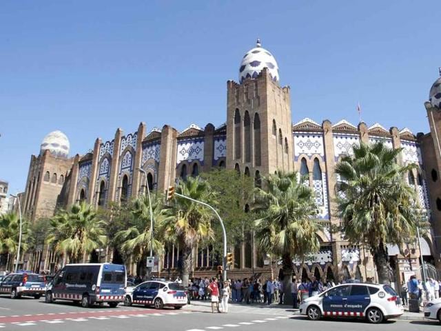 Police vehicles are seen in front of the Monumental bullring in central Barcelona.