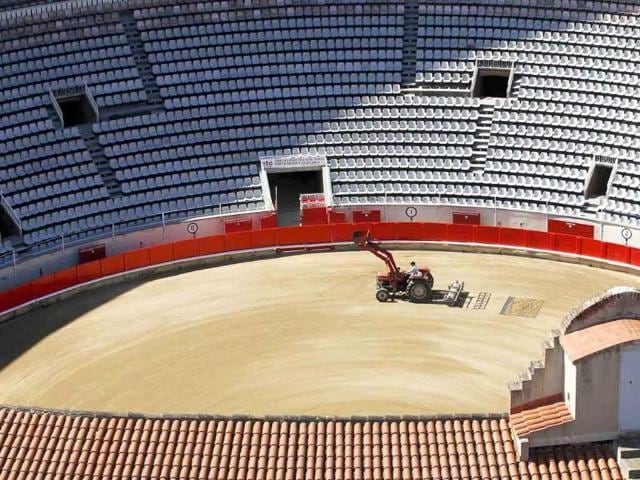 A tractor prepares the sand pit of the Monumental bullring in central Barcelona.