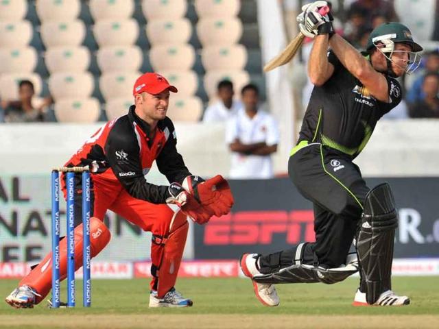 Warriors batsman Colin Ingram plays a shot as Timothy Paul Ludeman watches during the Champions League Twenty20 Group B cricket match in Hyderabad.