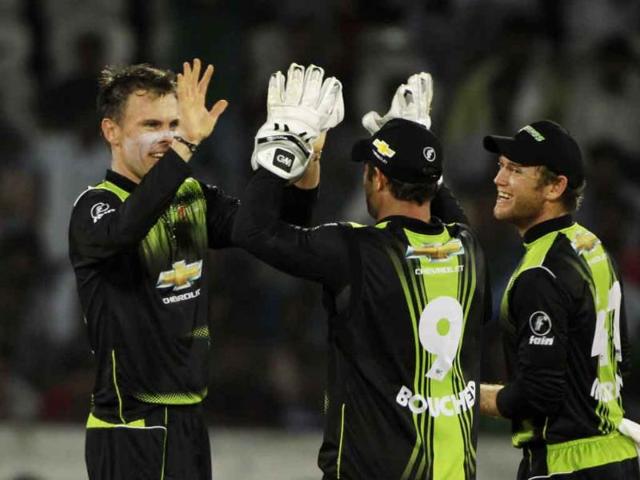 Warriors bowler Johan Botha (L) celebrates the wicket of South Australia's batsman during the Champions League Twenty20 cricket match in Hyderabad.