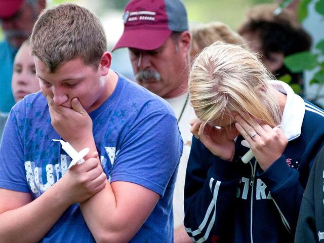 Two young people react while attending the Reno memorial service for the victims of the September 16 crash at the National Championship Air Races.