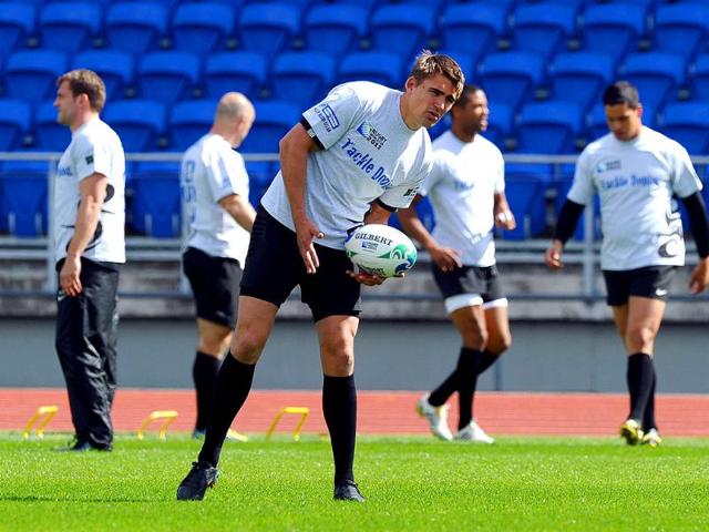 England's Toby Flood (C) catches a ball during a training session in Auckland, New Zealand.