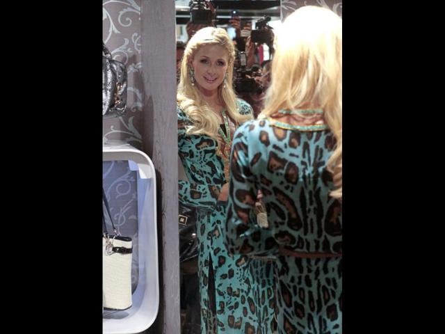 Paris can't seem to take her eyes off herself in this designer dress.