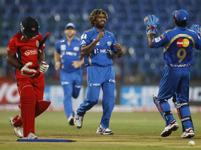 Mumbai Indians bowler Lasith Malinga (C) celebrates the dismissal of Trinidad and Tobago batsman Adrian Barath (L) during their Champions League Twenty20 cricket match in Bangalore.