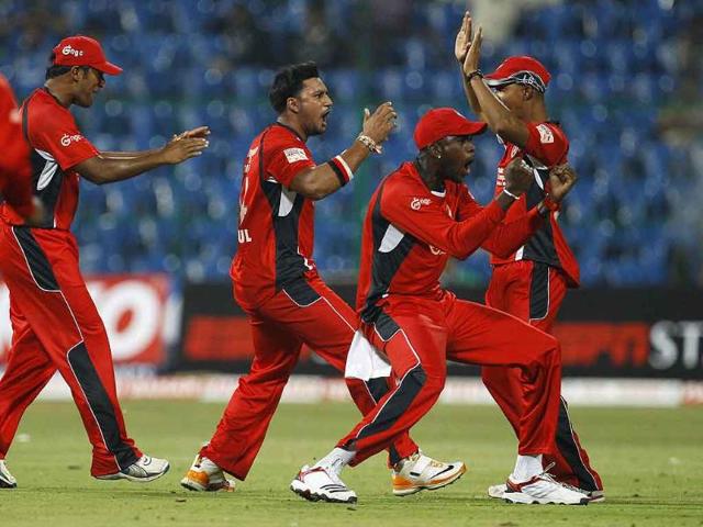 Trinidad and Tobago bowler Ravi Rampaul (2L) celebrates with teammates the dismissal of Mumbai Indians batsman Andrew Symonds during their Champions League Twenty20 cricket match in Bangalore.