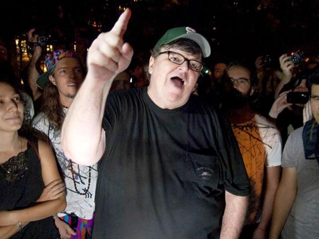 Filmmaker Michael Moore gestures during a visit to the Occupy Wall Street protest in Zuccotti Park in New York. Protesters are camping out in the lower Manhattan plaza to speak out against corporate greed and social inequality.