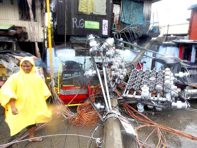 An electric post is seen after it slammed into a house after heavy winds brought by Typhoon Nesat, locally known as Pedring, hit Tondo city, metro Manila.