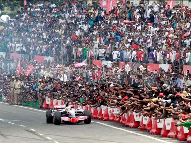 McLaren driver Lewis Hamilton of Britain performs on the Bangalore-Mysore highway during a promotional event ahead of the India Formula One Grand Prix, on the outskirts of Bangalore, India.