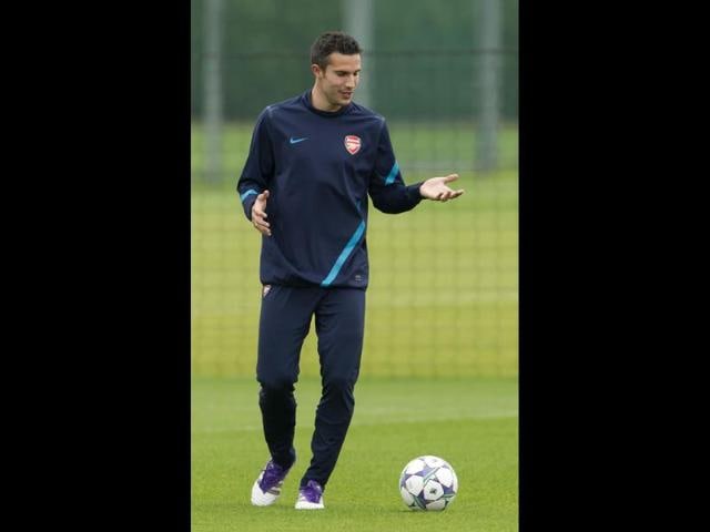 Arsenal's Robin van Persie takes part in a training session at the club's facilities in London Colney, England. Arsenal are due to play Olympiacos FC in a Champions League Group F soccer match at the Emirates Stadium in London.
