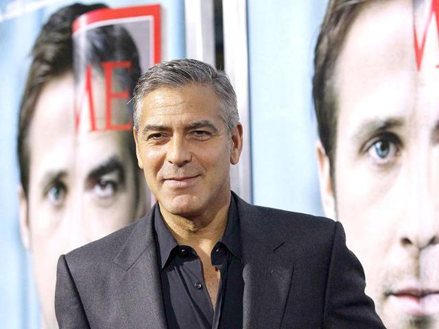 Director and cast member George Clooney poses at the premiere of The Ides Of March at the Samuel Goldwyn theatre in Beverly Hills, California.