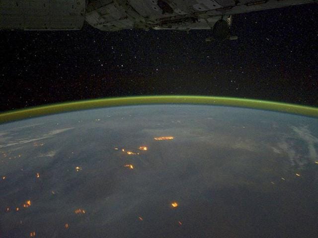 Fires, burn on the continent of Australia, with smoke plumes faintly visible in the night sky, in this picture taken by astronauts on the International Space Station using a digital camera.
