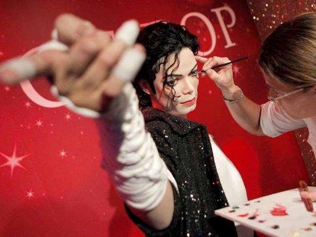 Figure production maintenance manager Petra van der Meer retouches Michael Jackson's wax figure at the Madame Tussauds exhibition in Tokyo, Japan.