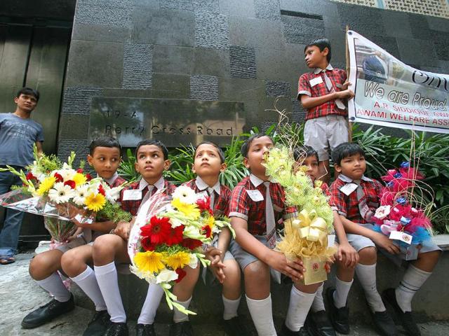 School children wait in front of Sachin Tendulkar's new house at Perry Cross Road in Bandra, Mumbai.