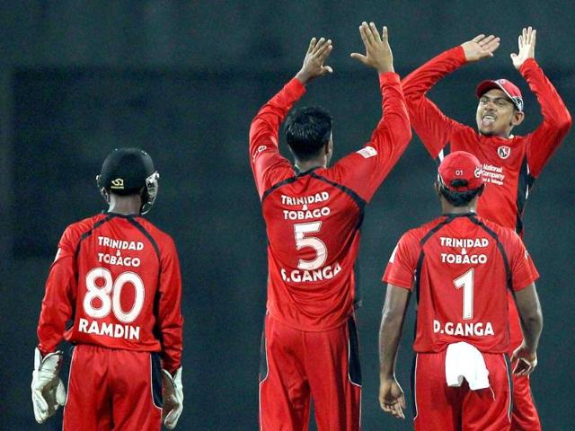 Trinidad & Tobago's Sherwin Ganga along with teammates celebrate the wicket of New South Wales Blues' Daniel Smith during the Champions league T20-2011 match in Chennai.