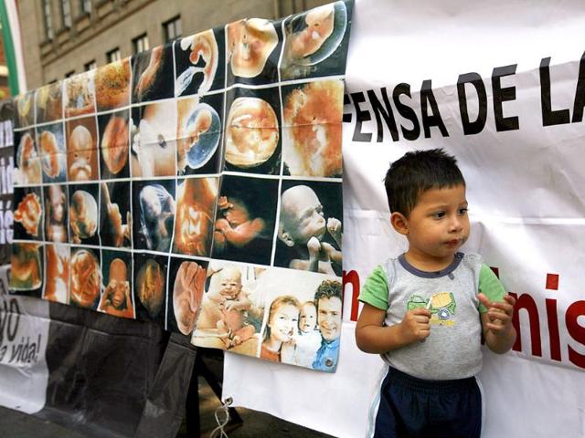 A child looks on during a demonstration against legalizing abortion in Mexico City.