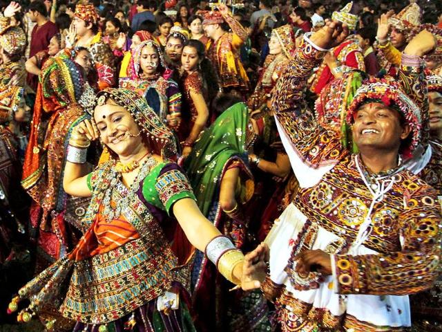People in traditional attire take part in Garba, a traditional dance of Gujarat on the first night of nine nights festival Navratri in Ahmadabad.