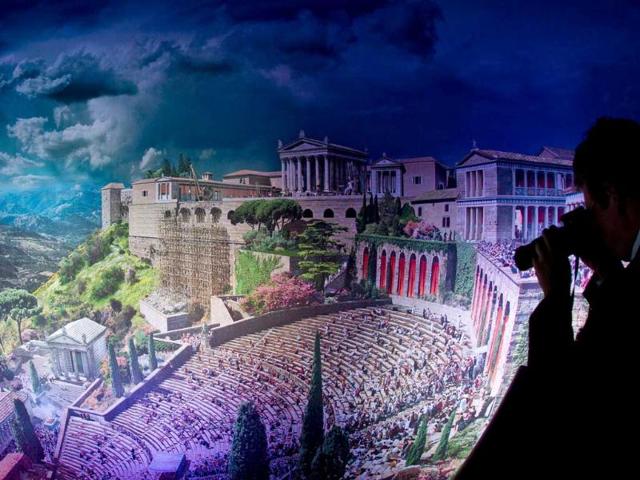 A visitor looks at the work titled "Pergamon - Panorama of the Ancient Metropolis" during a preview on September 29, 2011 at the Pergamon museum in Berlin. The giant 360 degrees panorama measuring 103 meters in length and 25 meters in height by Austrian-born artist of Iranian origin Yadegar Asisi will be on display at Berlin's Pergamon Museum - Classical Antiquities Collection from September 30, 2011 to September 30, 2012.