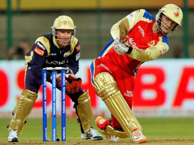 Daniel Vettori of Royal Challengers Bangalore knocks a six as wicketkeeper of Kolkata Knight Riders, Brad Haddin (L) looks during the Champions League Twenty20 League match between Royal Challengers Bangalore and Kolkata Knight Riders at the M. Chinnaswamy Stadium in Bangalore.