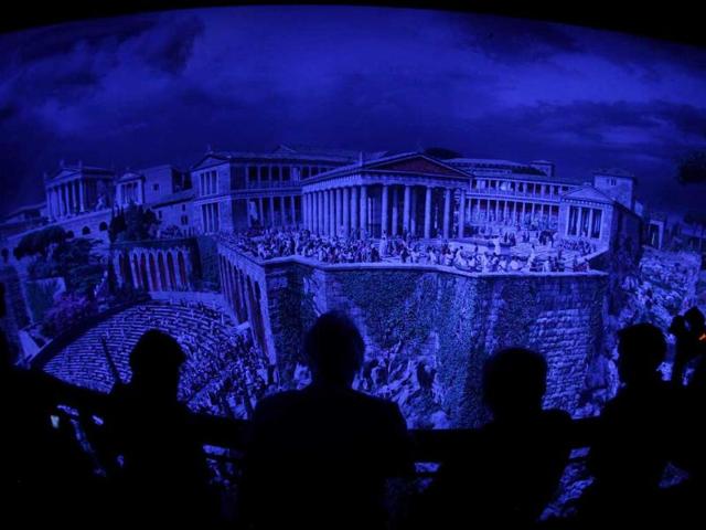 People watch the 'Pergamon - Panorama of the Ancient Metropolis' 360 degrees panorama created by artist Yadegar Asisi at an exhibition by the Collection of Classical Antiquities - National Museum during the press preview in Berlin. The condensed scenes depicted in Asisi panorama are 30 metres in height and 100 metres in length showing natural landscapes and the acropolis in Pergamon in the year 129 AD.