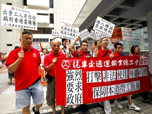 Protesters demonstrate against a Filipino domestic helper applying for permanent residency outside the high court of Hong Kong.