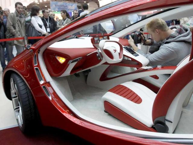 Visitors view a hybrid concept car from Russian car manufacturer e-Auto shown for the first time to the Russian public in St. Petersburg.