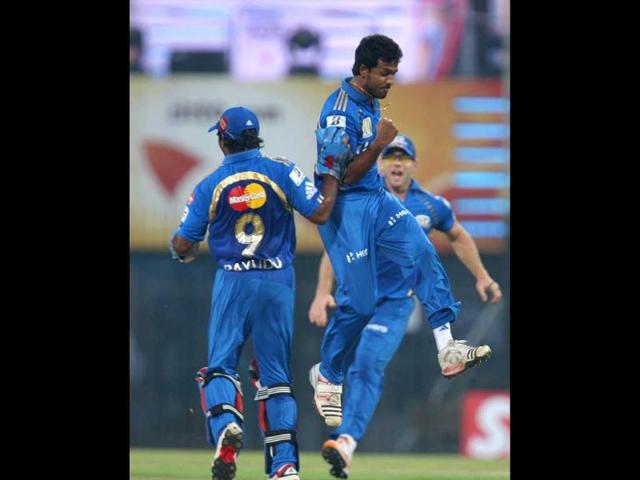 Mumbai Indian teammates Ambati Rayudu and Abu Nechim Ahmed celebrate the dismissal of Shane Watson of New South Wales Blues during their Champions League Trophy T20 match in Chennai.