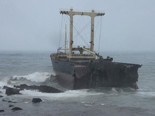 A cargo ship is seen stranded on the rocky shore on the north east coast just outside of the port city of Keelung, Taiwan.