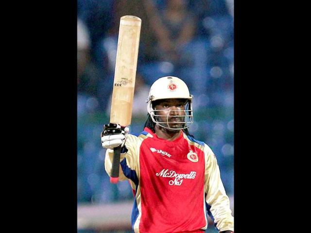Royal Challengers Bangalore batsman Chris Gayle celebrates his half century against Somerset during the Champions League T20-2011 match in Bangalore.