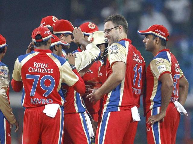 Royal Challengers Bangalore captain Daniel Vettori celebrates with teammates the dismissal of Somerset batsman Roelof van der Merwe, during the Champions League Twenty20 cricket match in Bangalore.