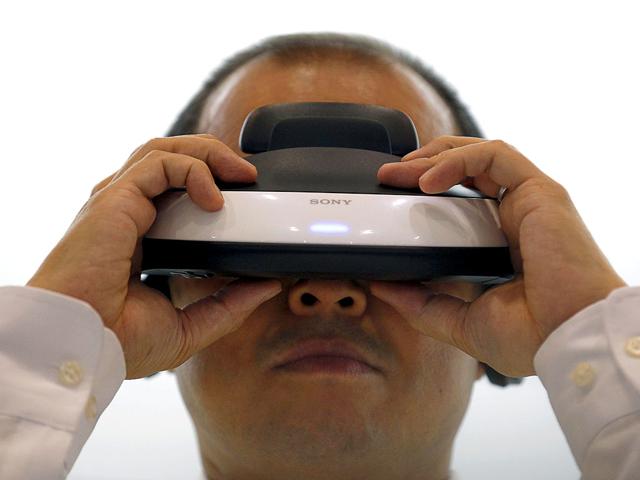 A visitor tries Sony Corp's head mounted display "Personnal 3D Viewer HMZ-T1" at CEATEC JAPAN 2011 electronics show in Chiba.
