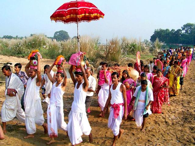 Priests along with devotees perform during Durga Puja festival in Bankura district in West Bengal.