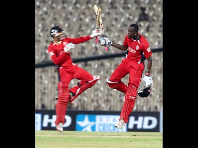 Sunil Narine (L) and Kevin Cooper of Trinidad and Tobago celebrate their win against Cape Cobras during their Champions League Trophy T20 cricket match at MA Chidambaram Stadium in Chennai.
