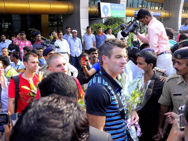 Blackburn Rovers FC captain Ryan Nelsen (R) arrives with teammates at the airport in Pune.