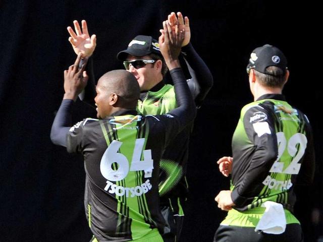 Warriors bowler Lonwabo Tsotsobe celebrates taking the wicket of Somerset batsman Peter Trego with his team mates during the Champions League Twenty20 League match at the M Chinnaswamy Stadium in Bangalore.