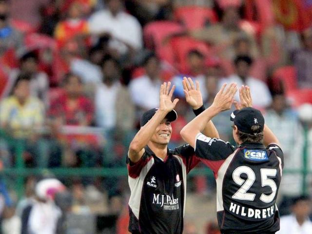 Somerset fielder Alfonso Thomas (L) celebrates the catch to dismiss Warriors batsman Ashwell Prince with Steven Kirby during the Champions League Twenty20 League cricket match between Warriors and Somerset at the M Chinnaswamy Stadium in Bangalore.
