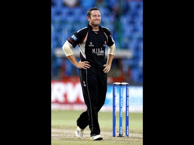 Somerset bowler Roelof van der Merwe reacts after Warriors batsman Colin Ingram (not seen) hit a boundary on his delivery during their Champions League Twenty20 cricket match in Bangalore.