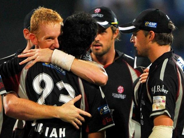 Somerset fielder Arul Suppiah is hugged by teammate Steven Kirby (L) after Suppiah dismissed Warriors batsman Johan Botha (unseen) during the Champions League Twenty20 League cricket match between Warriors and Somerset at the M Chinnaswamy Stadium in Bangalore.