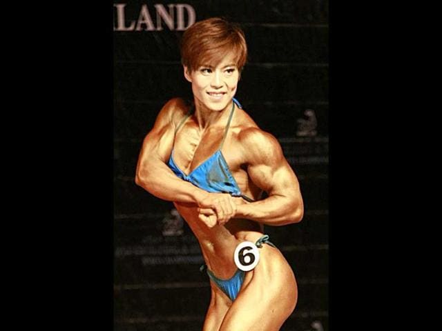 Liu Hongxia of China flexes her muscle at the competition of the 46-kilogram category of the Asian World Bodybuilding and Physique Sports Championship in Bangkok.