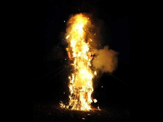 Kashmiri Pandits burn the effigy of Ravana, stuffed with fire-crackers during the Dussehra festival in Srinagar.