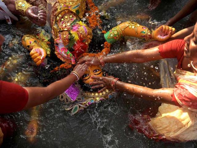 Hindus immerse an idol of the goddess Durga in the river Mahananda during the Vijaya Dashami or Dusshera Festival in Siliguri on the final day of Durga Puja.