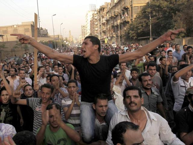 Angry Egyptian Christians protest outside St. Mark's Cathedral against the military ruling council in Cairo, a day after 24 people, mostly Christians, died in clashes with Egyptian security forces.