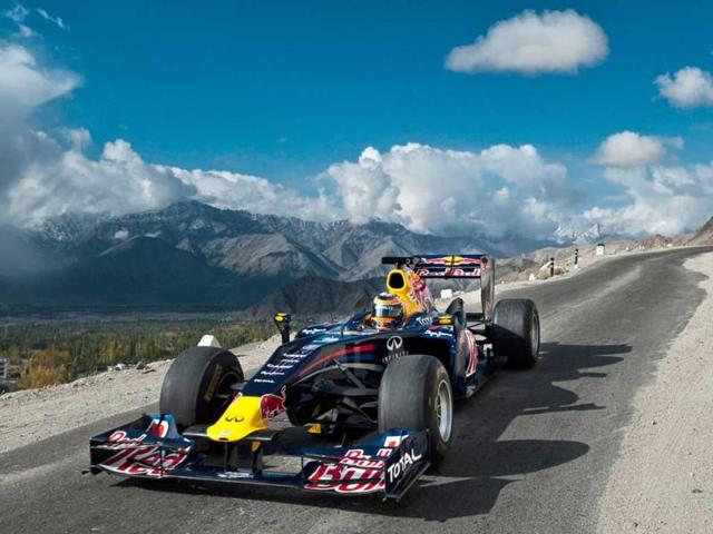 In this handout photo released on October 11, 2011, Red Bull Racing driver Neel Jani drives the Red Bull Racing Formula One show car on the world’s highest motorable road at 18,380 feet on the Khardung-La pass in Leh region.