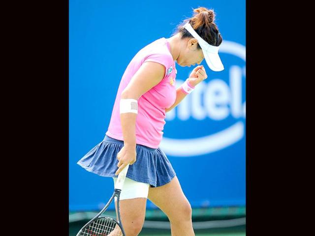 Tamarihne Tanasugarn of Thailand reacts after winning a point against Mathilde Johansson of France during their women's second round match of the Japan Women's Open tennis tournament in Osaka, western Japan.