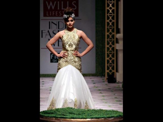 Kangna stuns in a white and gold gown.`