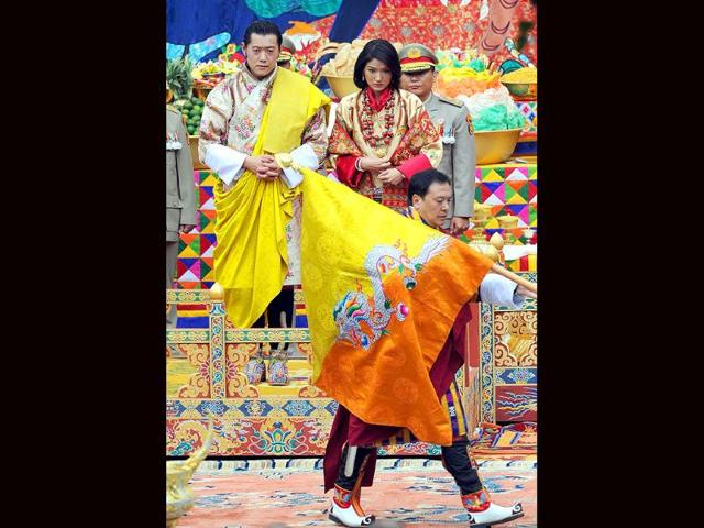 King of Bhutan and future queen stand together during their marriage ceremony in the main courtyard of the 17th-century fortified monastery or dzong in Punakha.