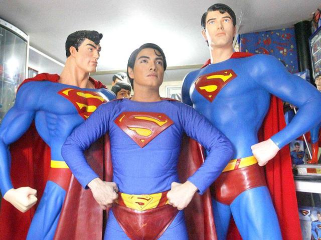 Herbert Chavez poses with his life-sized Superman statues inside his house in Calamba Laguna, south of Manila.